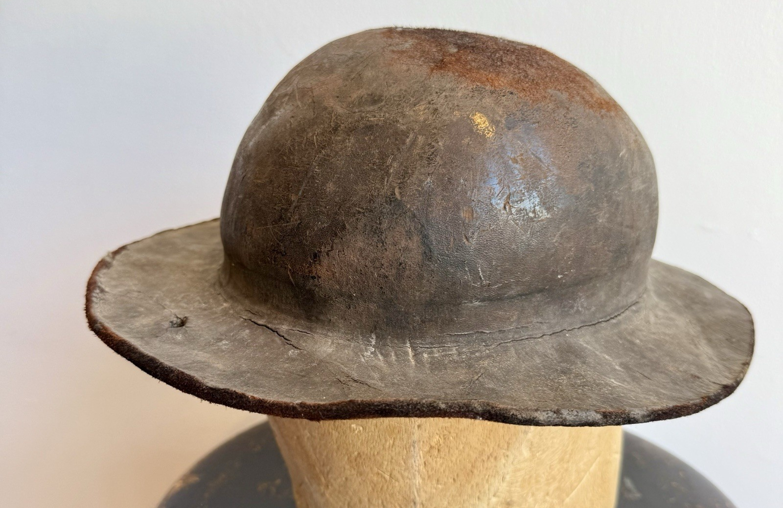 A picture of an nondescript 1800's leather miner's helmet.